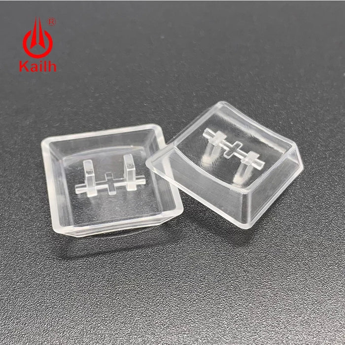 A macro photo showing the top and bottom of two transparant Choc keycaps.