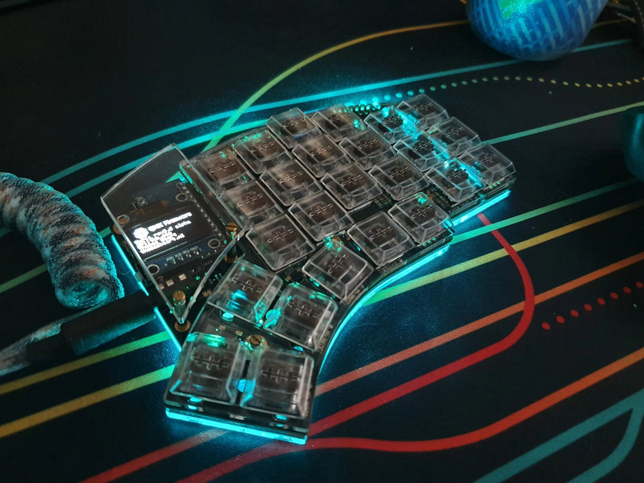 The right half of a Kyria in a clear plate case, with choc switches and transparant keycaps, showing bright teal underglow.
