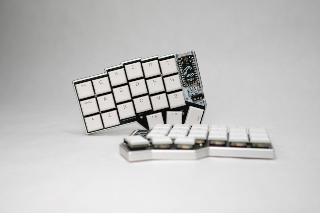 A front view of the Corne LP case, with one half displayed on its side, with a dark background.