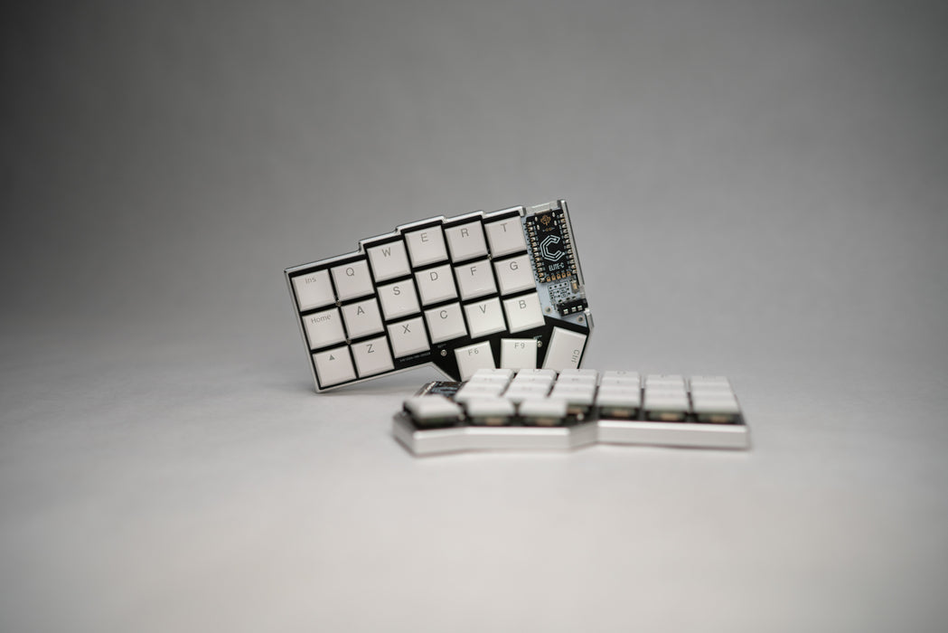 A front view of the Corne LP case, with one half displayed on its side, with a dark background.