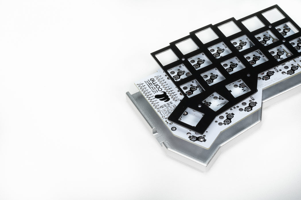 A disassembled view of the Corne LP case, showing the PCB and the FR4 plate.