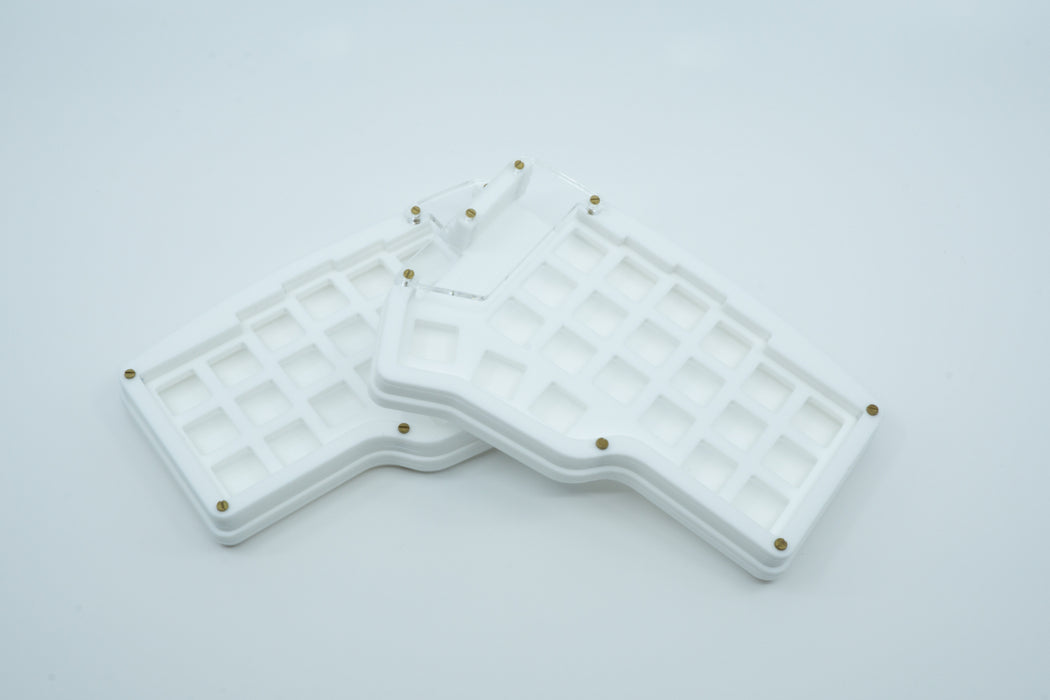 An arctic Corne Wave case, showing the matte white layers and clear OLED windows.