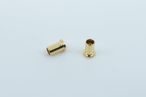 A macro photo of two Mill Max 7305 sockets, with one showing the side and one showing the top and part of the inside.