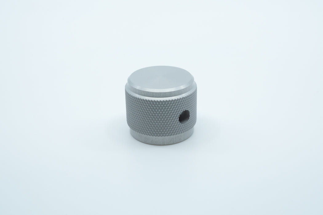 A macro photo of the side of a silver knurled aluminium encoder knob.