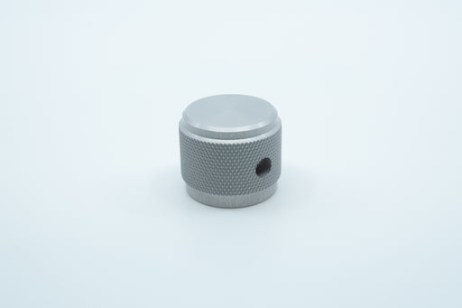 A macro photo of the side of a silver knurled aluminium encoder knob.