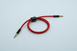 A red TRRS cable, with an outer housing of braided fabric, bundled with a piece of velcro.